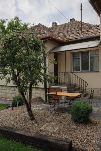 a table and bench in front of a house at TripON cozy spot in Cluj-Napoca