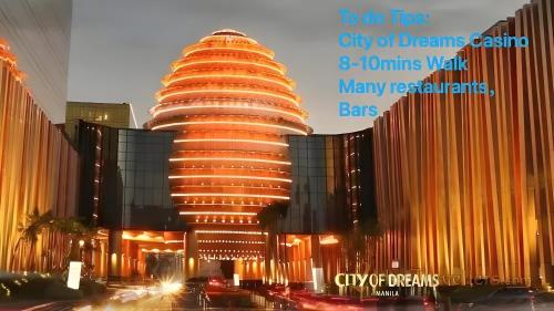 a tall building with a lot of lights on it at Perfect 1BR With Magnificant Bayview Garden View Near Okada, Solaire, Aiports, FREE PARKING in Manila