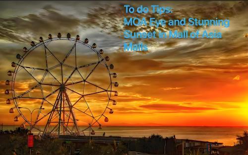 a ferris wheel with a sunset in the background at Perfect 1BR With Magnificant Bayview Garden View Near Okada, Solaire, Aiports, FREE PARKING in Manila