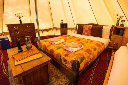 a bedroom with a bed with two towels on it at West Lexham Retreat in Kings Lynn
