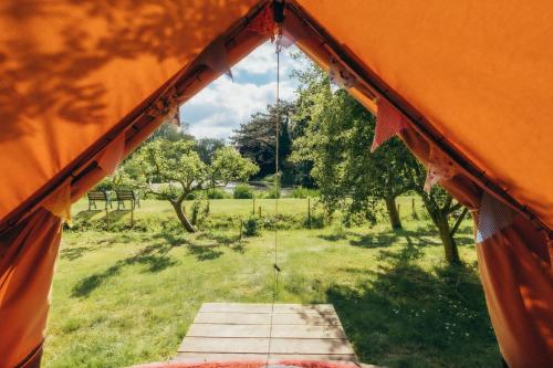 an inside of a tent with a view of a field at West Lexham Retreat in Kings Lynn