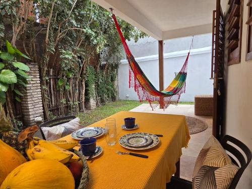 a yellow table with plates of food on it at Azul Flats in Jericoacoara