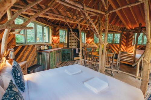 a room with a white table in a wooden house at West Lexham Retreat in Kings Lynn