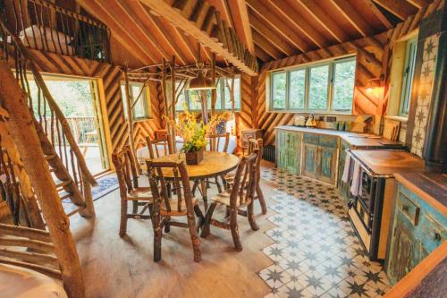 a dining room with a table and chairs in a cabin at West Lexham Retreat in Kings Lynn