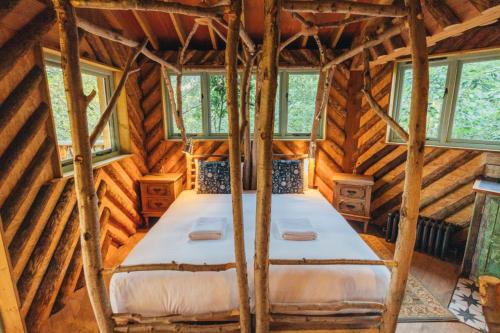 a bedroom in a log cabin with a bed in it at West Lexham Retreat in Kings Lynn