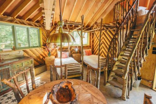 a room with a spiral staircase in a log cabin at West Lexham Retreat in Kings Lynn