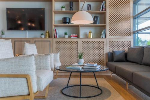 a living room with a couch and a table at Hotel Münster Kongresscenter affiliated by Meliá in Münster
