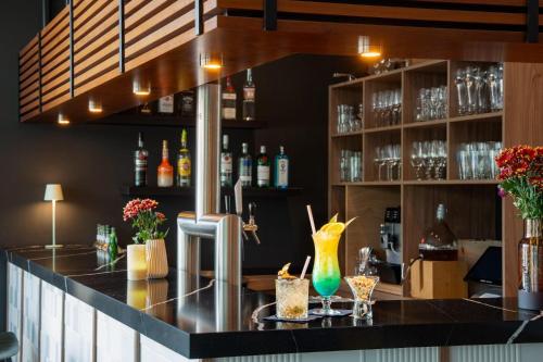 a bar with a counter with some drinks at Hotel Münster Kongresscenter affiliated by Meliá in Münster