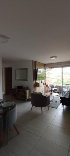 a living room with a couch and a table at Senderos in Pereira