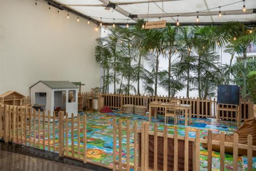 a nursery with a crib and a play area with trees at Radisson Blu Hotel & Convention Centre Kigali in Kigali