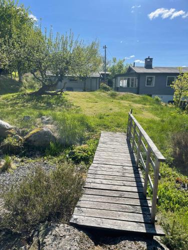 a wooden bridge over a field with a house at Family Cabin With Fjord Views In Drøbak Heights in Drøbak