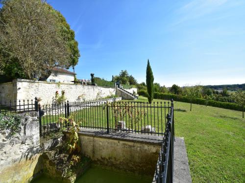 a pool of green water next to a fence at Holiday Home in Lusignac with Private Pool in Lusignac