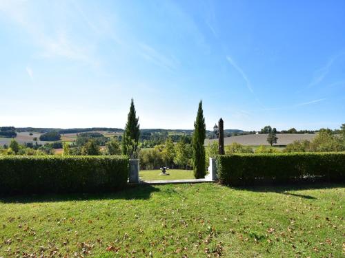 a garden with bushes and trees in a field at Holiday Home in Lusignac with Private Pool in Lusignac