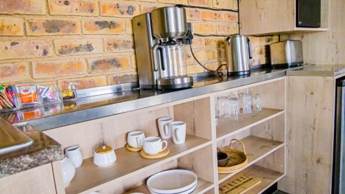a kitchen with wooden shelves with cups and appliances at Bella Vista in Johannesburg