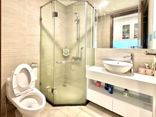 a bathroom with a shower and a toilet and a sink at Great Studio Apt Near Marriott Hotel And My Dinh Stadium in Hanoi