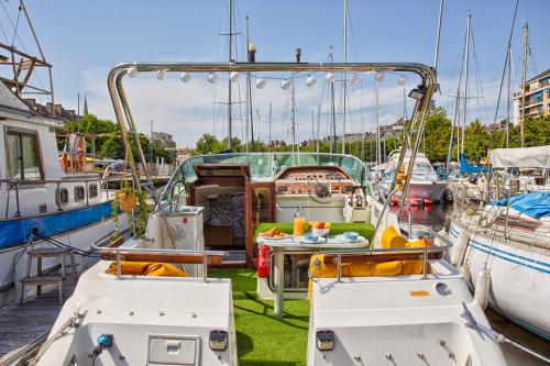 a group of boats docked in a marina at Séjour Insolite sur Ulysse - Bateau - Port de Caen in Caen