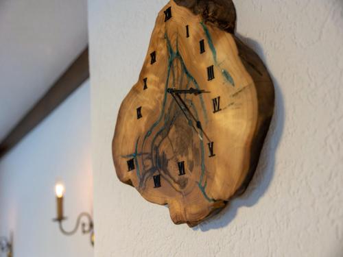 a wooden clock is hanging on a wall at Apartment in Muhr near Ski Areas in Muhr