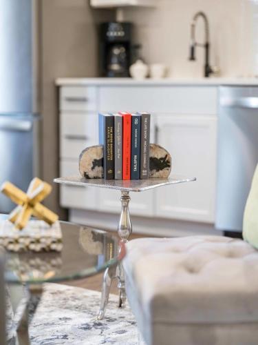 a table with books on top of a table at The Warhol - Pet-Friendly Apartment in Bentonville