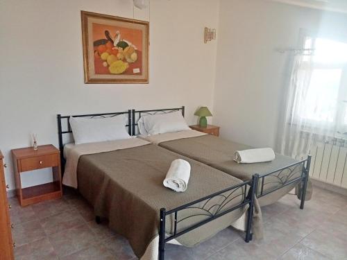 a bedroom with a large bed with two towels on it at Vista Alcantara - Wellness Mountain-Top Retreat in Motta Camastra