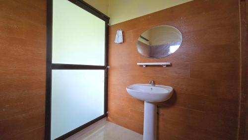 a bathroom with a sink and a mirror at Khao Sok Horizon in Ban Bang Thong