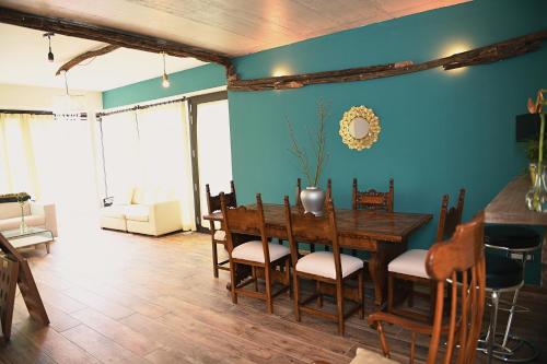 a dining room with a wooden table and chairs at Italianflat - FREE parking, Salted Swimmingpool - Casa Ulivi del Garda in Castion Veronese