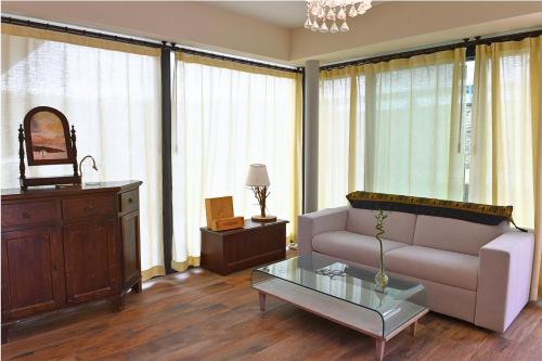 a living room with a couch and a table at Italianflat - FREE parking, Salted Swimmingpool - Casa Ulivi del Garda in Castion Veronese