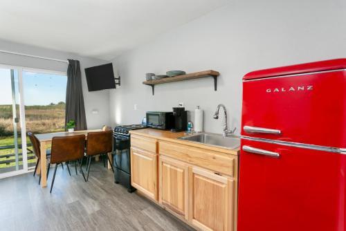 a red refrigerator in a kitchen with a table at Breakwater Resort in Grayland