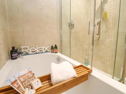 a bathroom with a bath tub with a shower at Sea Breeze in Carbis Bay