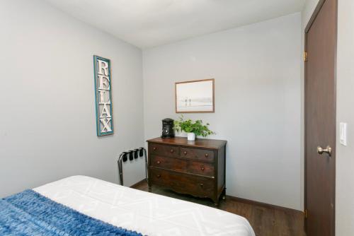 a bedroom with a bed and a dresser at Breakwater Resort in Grayland