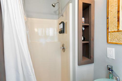 a shower in a bathroom with a shower curtain at Breakwater Resort in Grayland