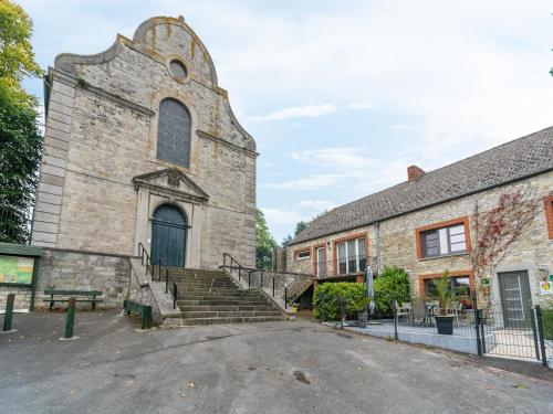 an old stone church with stairs in front of it at Scenic Retreat in Gimnée in Doische