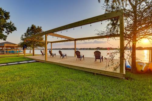 a wooden deck with chairs and a view of the water at Boat, Fish and Swim Lake Conroe Home with Hot Tub! in Willis