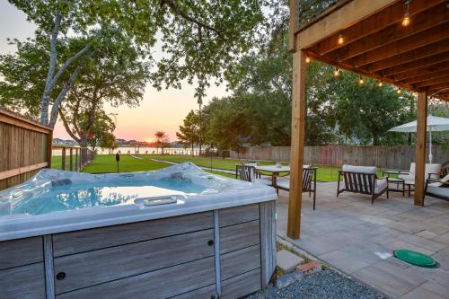 a jacuzzi tub in a yard with a patio at Boat, Fish and Swim Lake Conroe Home with Hot Tub! in Willis