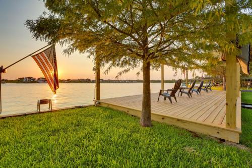 a dock with chairs and a tree and the water at Boat, Fish and Swim Lake Conroe Home with Hot Tub! in Willis