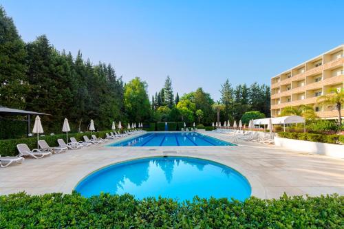 une piscine avec des chaises longues et un hôtel dans l'établissement Crowne Plaza Rome St. Peter's by IHG, à Rome