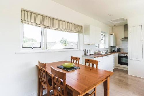 eine Küche mit einem Holztisch und Stühlen in der Unterkunft 2 Bed Cottage Abersoch - close to beach and village - Pet Free in Abersoch