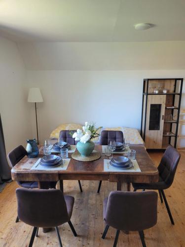 a living room with a wooden table and chairs at Kolo a ryby Bulhary in Břeclav