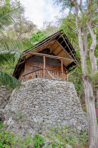 a building on top of a stone wall at Sangat Island Dive Resort in Coron
