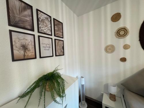 a room with a table and pictures on the wall at BOHO Apartment Aura in Bad Reichenhall