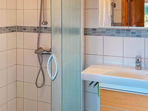 a bathroom with a shower and a sink at Serene Seaside Retreat in Vesteroy-By Traum in Hauge
