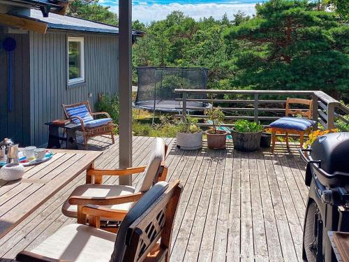 a patio with chairs and a table and a bench at Serene Seaside Retreat in Vesteroy-By Traum in Hauge