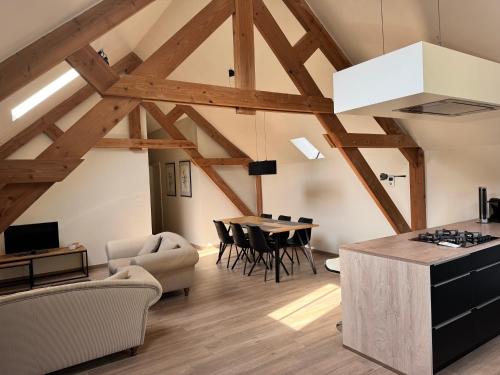 a kitchen and living room with a table and chairs at De Oude Molen in As