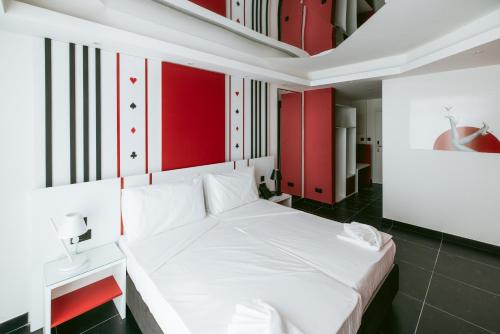 a bedroom with a white bed and red cabinets at Las Vegas Resort Malta in St. Julianʼs