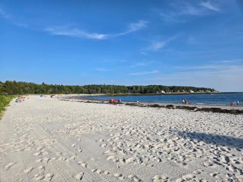 a beach with a lot of people on it at Hotel Pemaquid in Bristol
