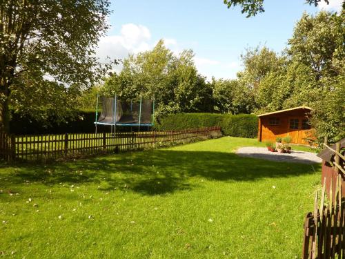a yard with a fence and a playground at Peaceful Garden Stay, Malmedy in Malmedy