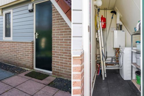 a front door of a house with a brick wall at Lovely bungalow with woodburner and airco in Zwiggelte