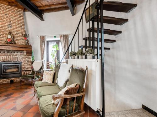 a living room with a couch and a staircase at Charming Nieuwpoort Mill Retreat in Zottegem