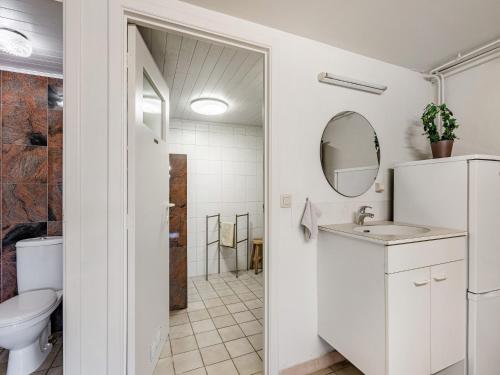 a white bathroom with a sink and a toilet at Charming Nieuwpoort Mill Retreat in Zottegem