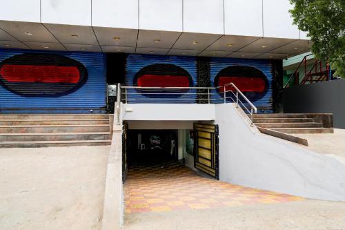 a staircase leading to a building with red and blue windows at Hotel O 5 Five Star in Upal