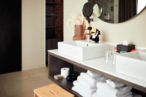 a bathroom with two sinks and a mirror at Van der Valk Hotel Gent in Ghent